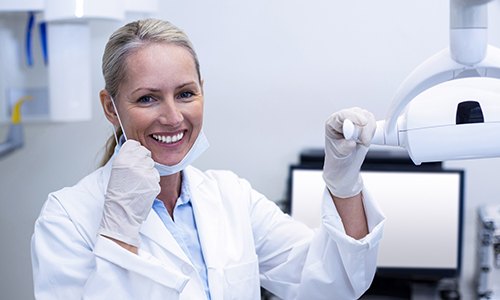 Dentist smiling in dental exam room