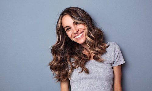 Smiling woman with a dental bridge in Braintree 