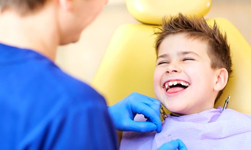 Little boy smiling at Brain tree dentist after getting dental sealants