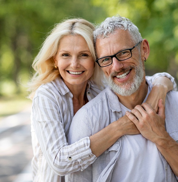 Smiling couple after visiting their Cigna dentist in Braintree