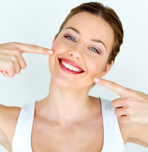 Woman pointing to beautiful smile
