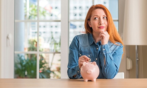 a person saving money in a piggy bank