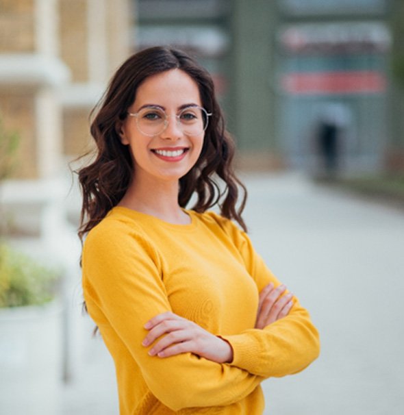 Woman in yellow shirt and glasses smilingdge