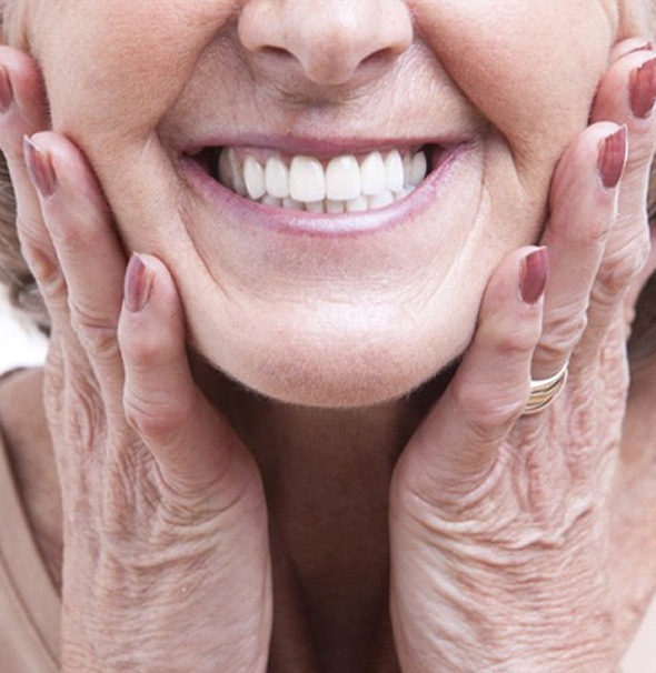 close up of elderly woman smiling with dentures in Braintree