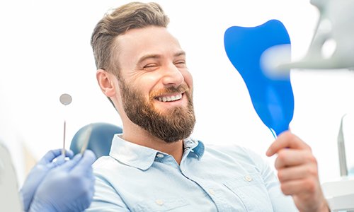 Man admiring new tooth-colored fillings in Braintree