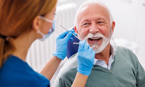 Mature man smiling during dental checkup 