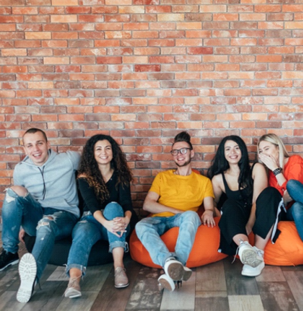 young adults sitting on beanbags and talking