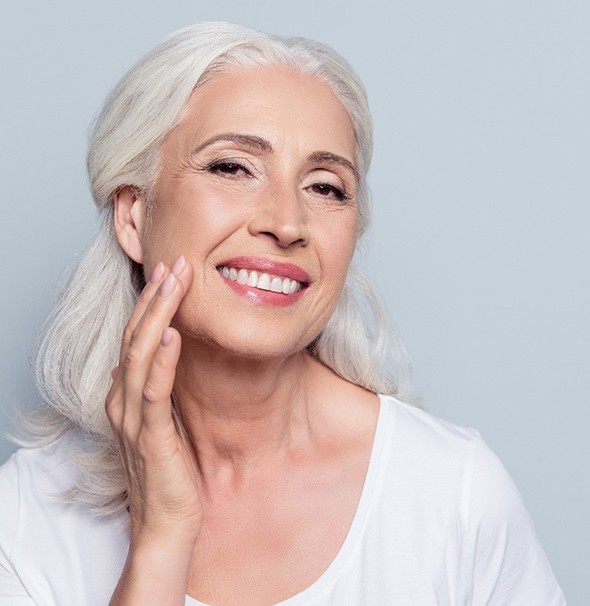 Woman with a complete smile using dental implants in Braintree.