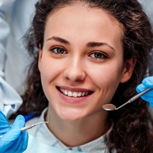 young woman with curly hair attending dental checkup