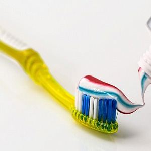 toothpaste on yellow toothbrush