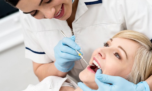 Woman receiving dental exam