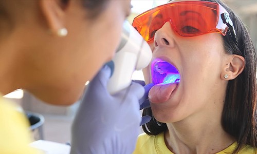 Woman receiving oral cancer screening