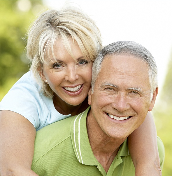 Smiling older man and woman outdoors