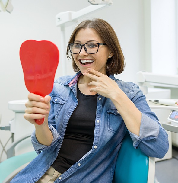 Woman looking at smile in mirror