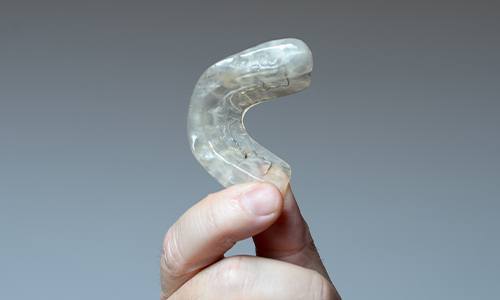 hand holding an occlusal splint