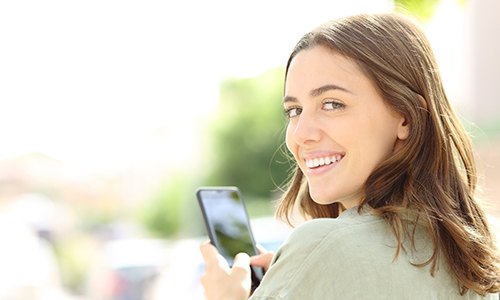 Woman with teeth whitening in Braintree smiling outside