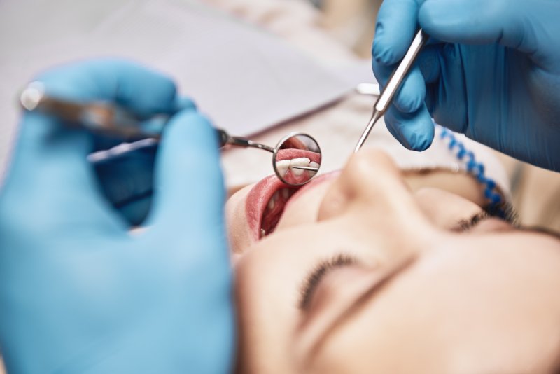 Dentist in Braintree checking patient's teeth