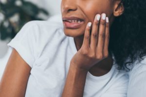 Closeup of woman suffering from warning signs of bruxism