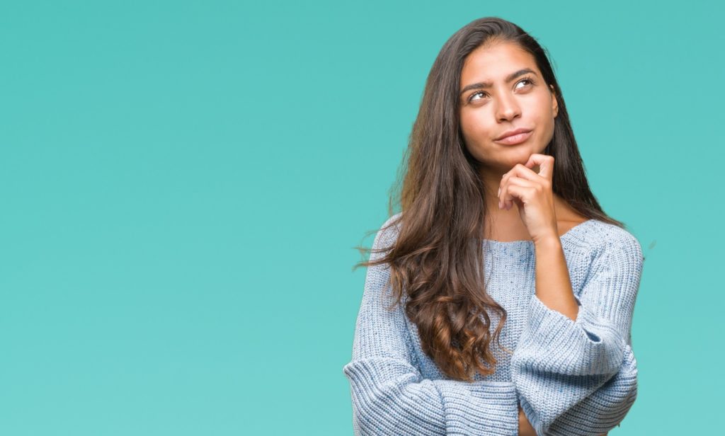 Woman in blue sweater wondering