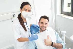 a dental hygienist and a patient smiling 