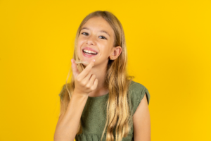 a teen with Invisalign smiling